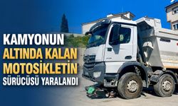 Kamyonun altında kalan motosikletin sürücüsü yaralandı