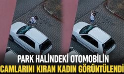 Park halindeki otomobilin camlarını kıran kadın görüntülendi