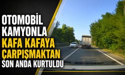 Otomobil kamyonla kafa kafaya çarpışmaktan son anda kurtuldu