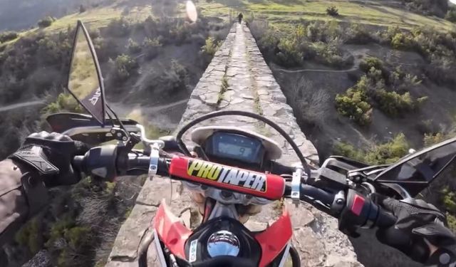 Tarihi yapının üzerinde tehlikeli motosiklet yolculuğu