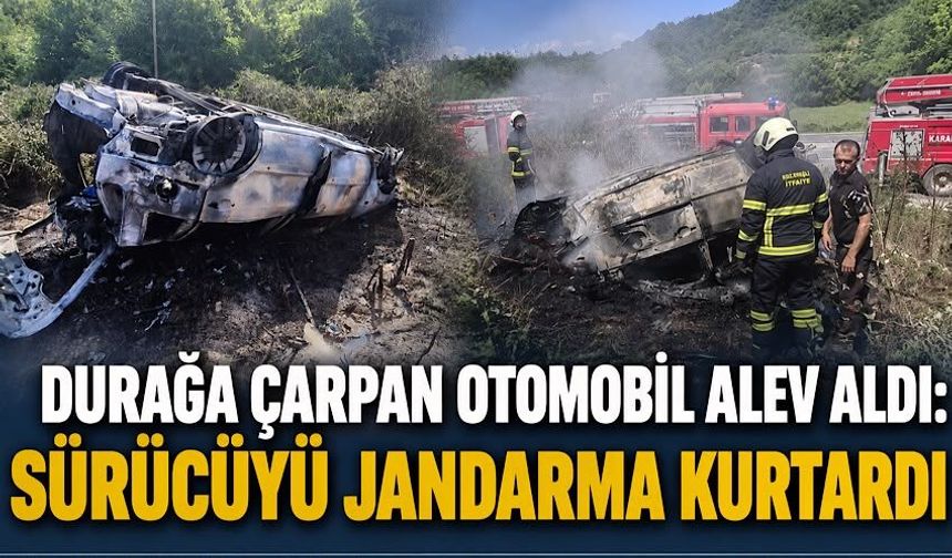 Durağa çarpan otomobil alev aldı: Sürücüyü jandarma kurtardı